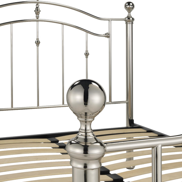 Metal bed frame with decorative posts on a white background