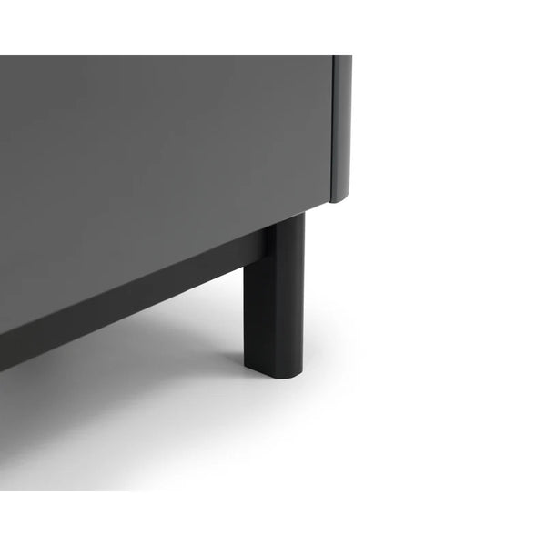 Close-up of a dark gray cabinet corner with a black leg on a white background