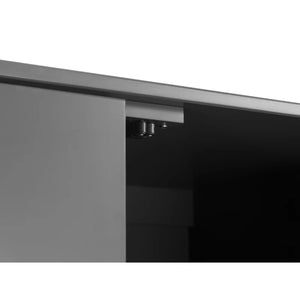 Close-up of a black cabinet with a metallic handle on a white background