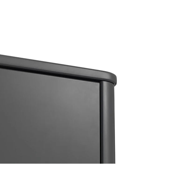 Close-up of a black metal surface with a white background