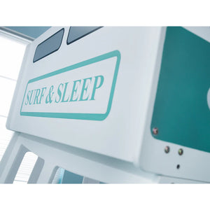 Close-up of a vehicle with 'Surf & Sleep' sign on a blurred background