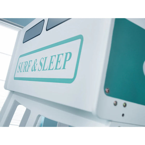 Close-up of a vehicle with 'Surf & Sleep' sign on a blurred background