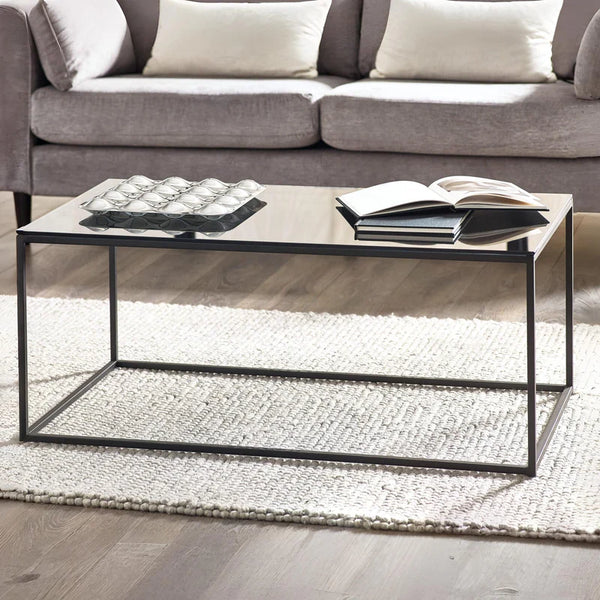 Coffee table with decorative items in a living room setting
