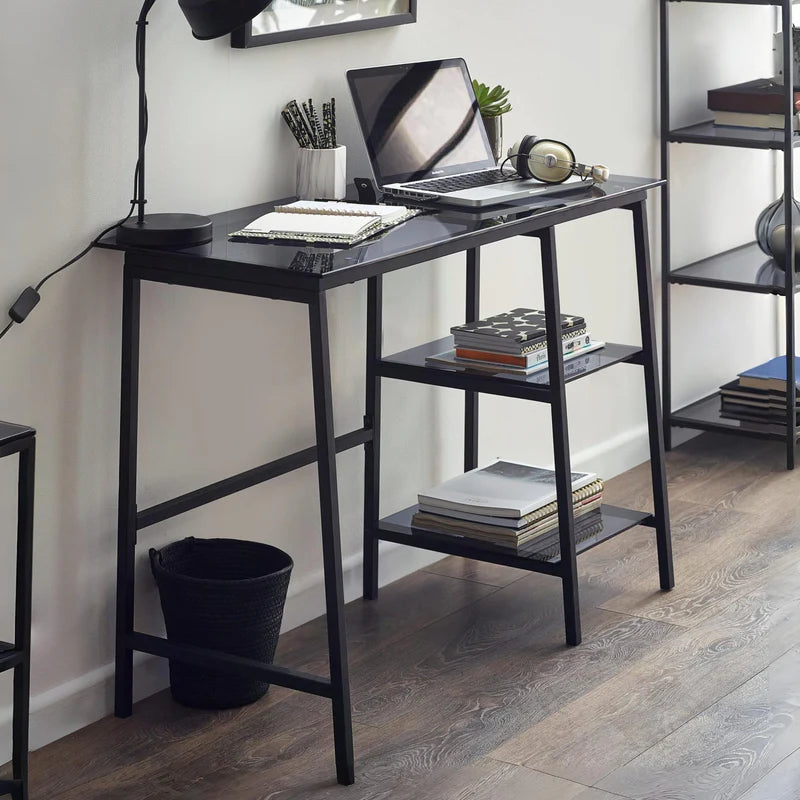 Black metal desk with glass top on a white background