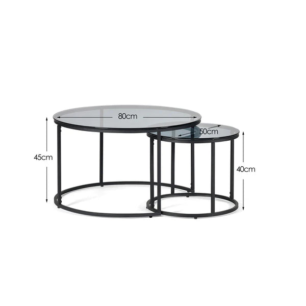 Set of two round glass tables with metal bases, shown with dimensions on a white background.