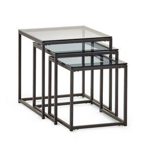 Set of three nesting tables with glass tops and black metal frames on a white background