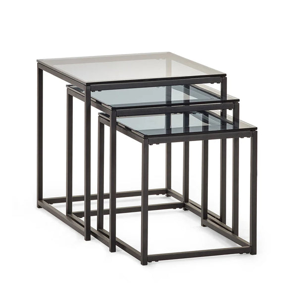 Set of three nesting tables with glass tops and black metal frames on a white background