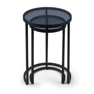 Black metal side table with smoked glass top on a white background