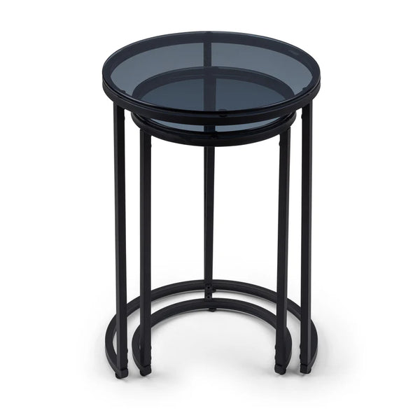 Black metal side table with smoked glass top on a white background
