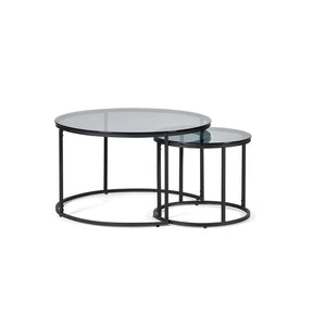 Set of two round glass coffee tables with black metal frames on a white background