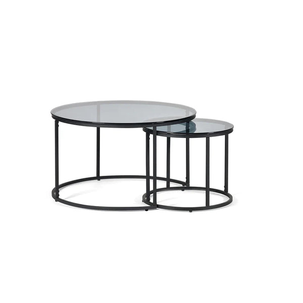 Set of two round glass coffee tables with black metal frames on a white background