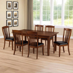 Dining room with wooden table and chairs in front of a window.