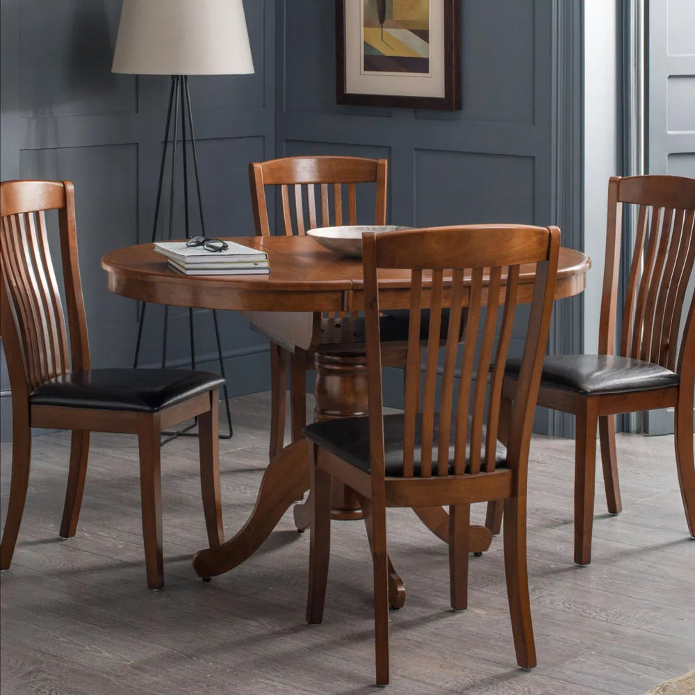 Wooden round table with a pedestal base on a white background