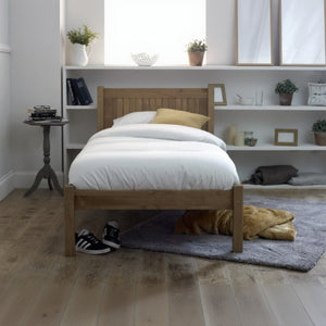 Wooden bed in a room with shelves and decor
