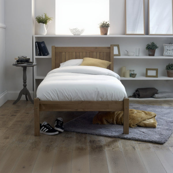 Wooden bed in a room with shelves and decor