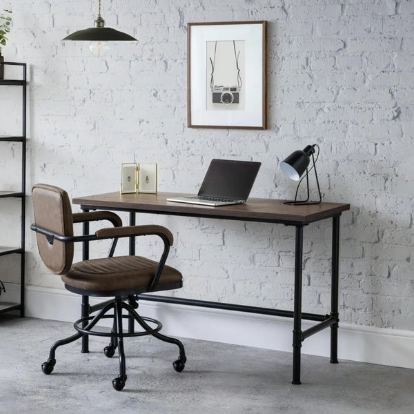 Modern office desk with chair against a white brick wall