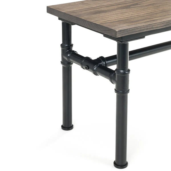Table with wooden top and black metal pipe legs on a white background