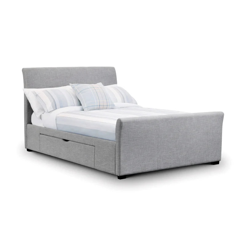 Gray upholstered bed with white bedding and pillows on a white background