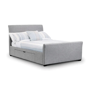 Gray upholstered bed with white bedding and pillows on a white background
