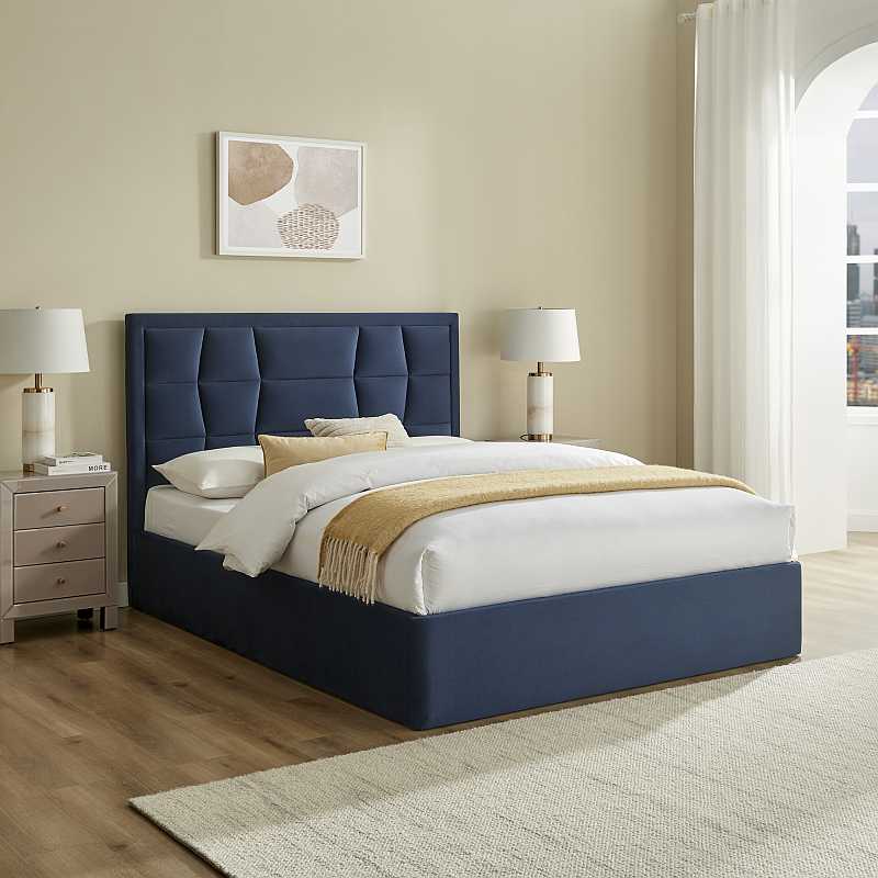 Navy blue bed frame with white mattress on a white background