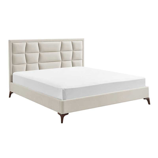 Beige upholstered bed with white mattress on a white background