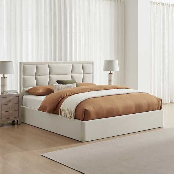 Neatly made bed with brown bedding in a bedroom setting.