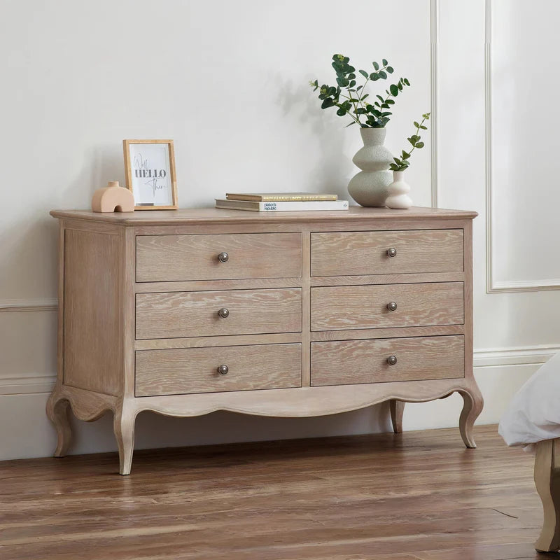 Wooden dresser with six drawers on a white background