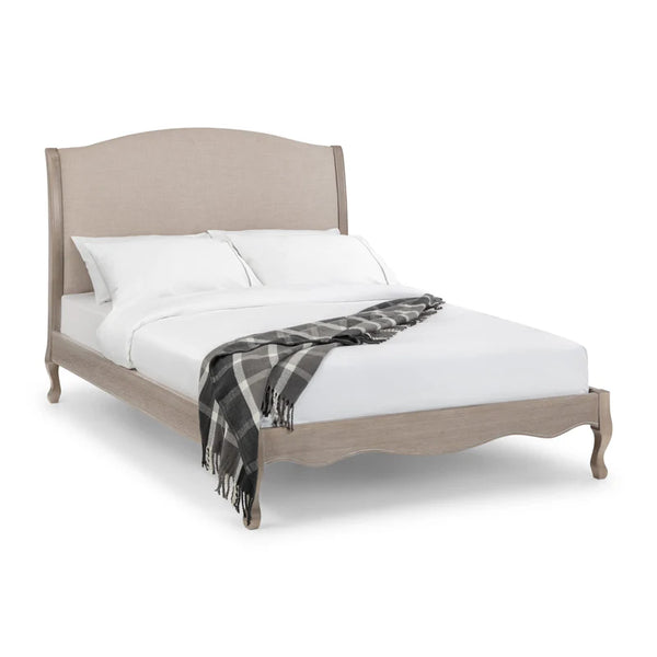 Bed with beige headboard and white bedding on a white background