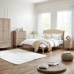 Neatly arranged bedroom with wooden furniture and white bedding