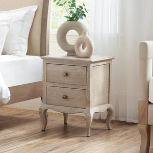 Limed oak wooden nightstand with two drawers in a bedroom setting