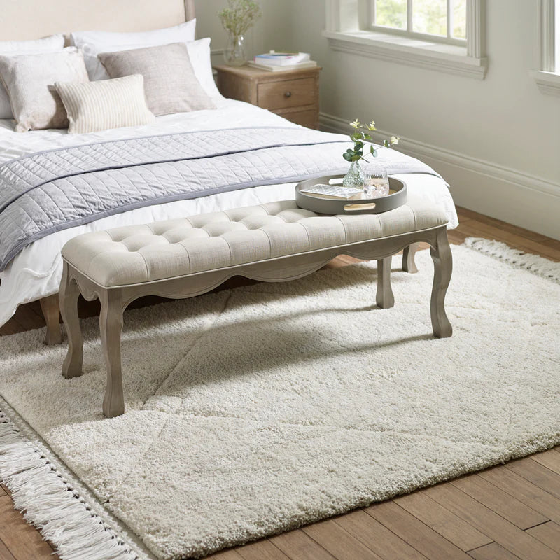 Decorative bench with tufted seat on a white background