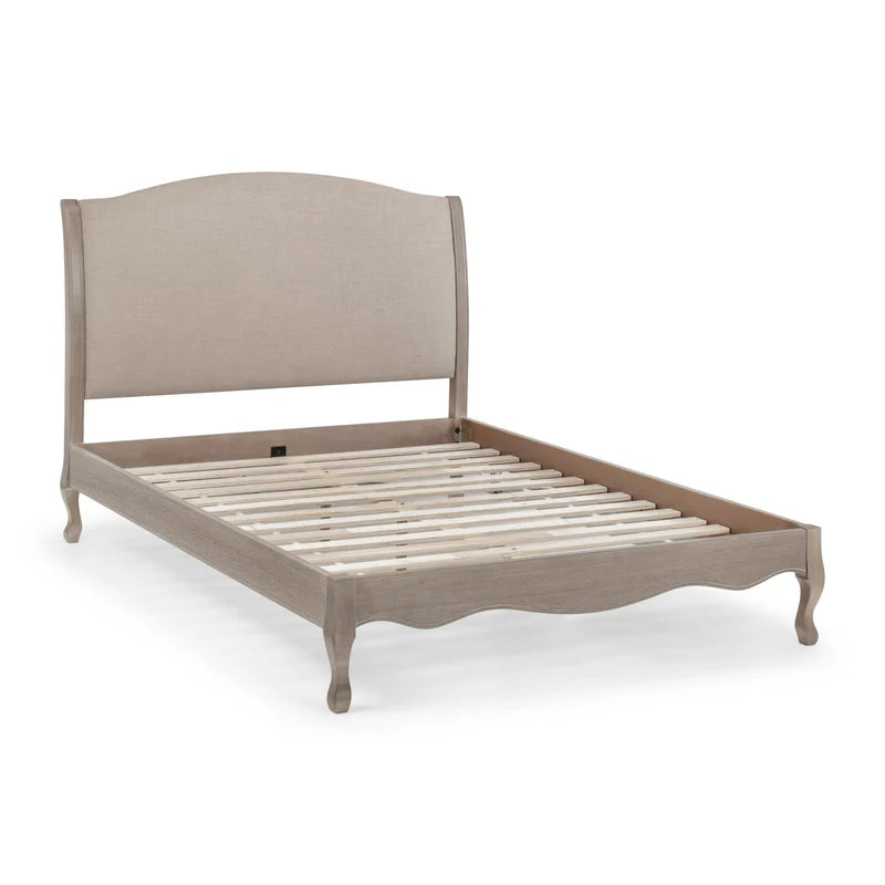 Wooden bed frame with beige headboard on a white background