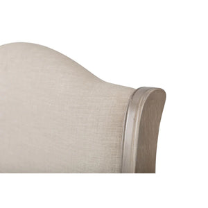 Close-up of a beige upholstered headboard with wooden trim on a white background