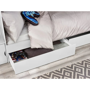 Bed with open drawer underneath, showing a neatly folded blanket and a shoe inside.