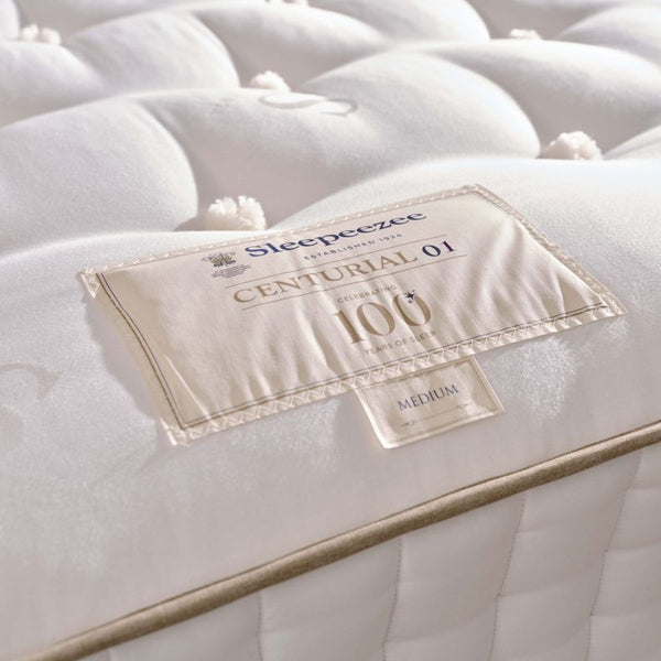 Close-up of a mattress with a label on a white background
