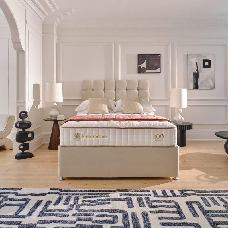 Sleepeezee Bed with mattress brand name in a modern bedroom setting