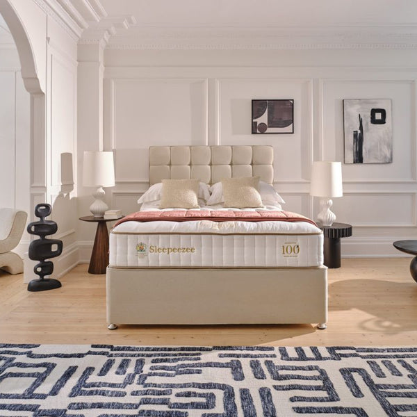 Bedroom with a mattress on a bed, surrounded by decor elements.