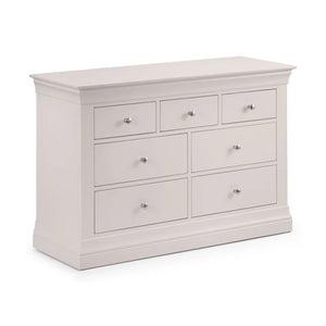 Grey dresser with multiple drawers on a white background