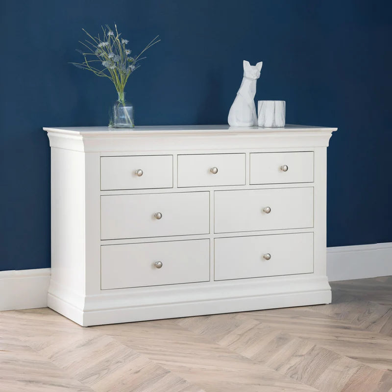 White dresser with multiple drawers on a white background
