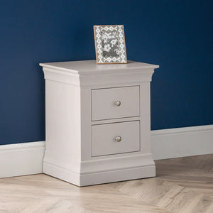 Gray nightstand with two drawers against a blue wall