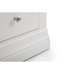 Close-up of a white dresser with a silver knob on a white background
