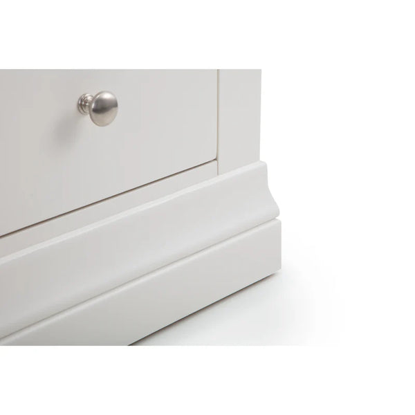Close-up of a white dresser with a silver knob on a white background