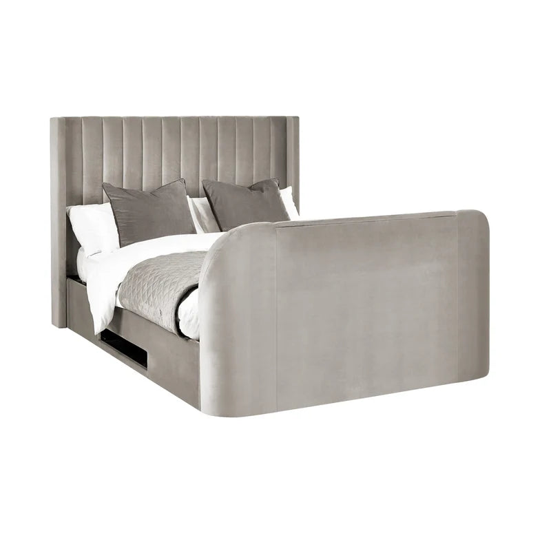 Gray upholstered bed with white bedding and gray pillows on a white background