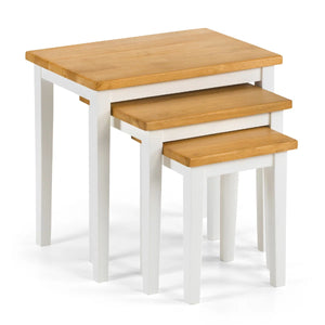 Set of three wooden nesting tables with white legs on a white background