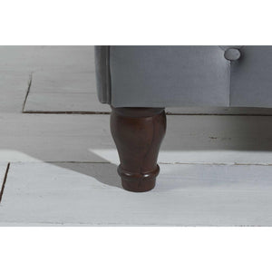 Close-up of a wooden bed leg on a light wooden floor