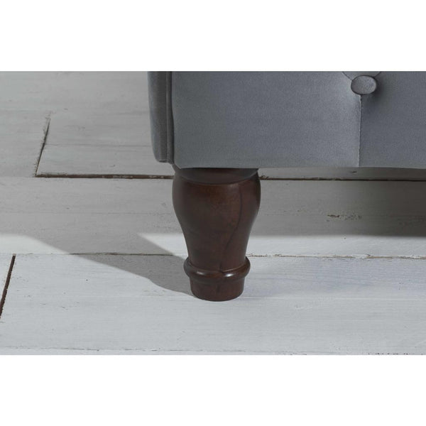 Close-up of a wooden bed leg on a light wooden floor