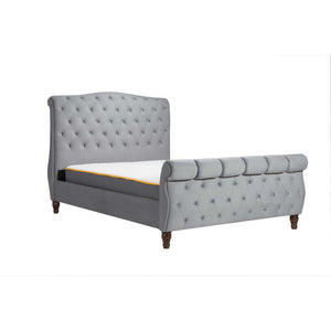Gray upholstered bed with tufted design on a white background