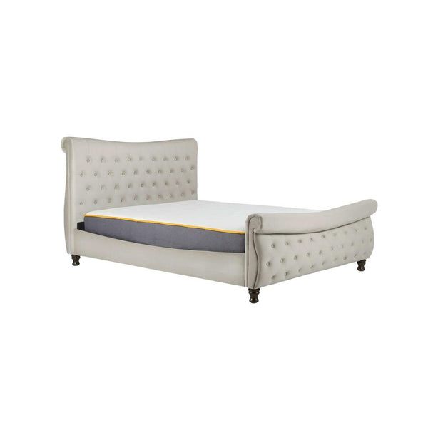 Beige upholstered bed with tufted details on a white background