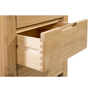 Wooden drawer being pulled out from a wooden cabinet.