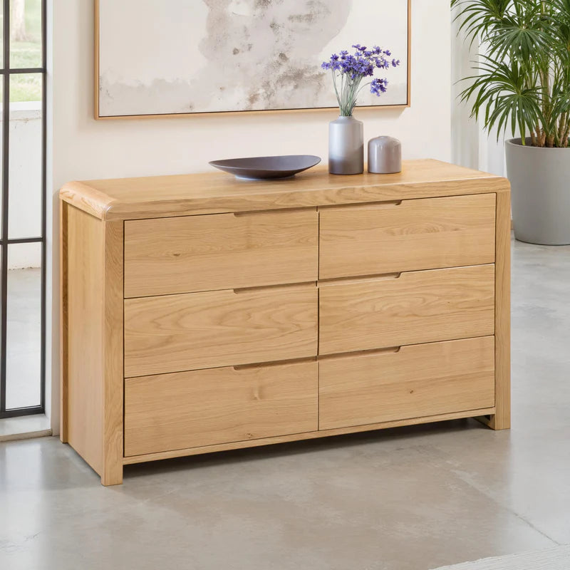Wooden dresser with six drawers on a white background